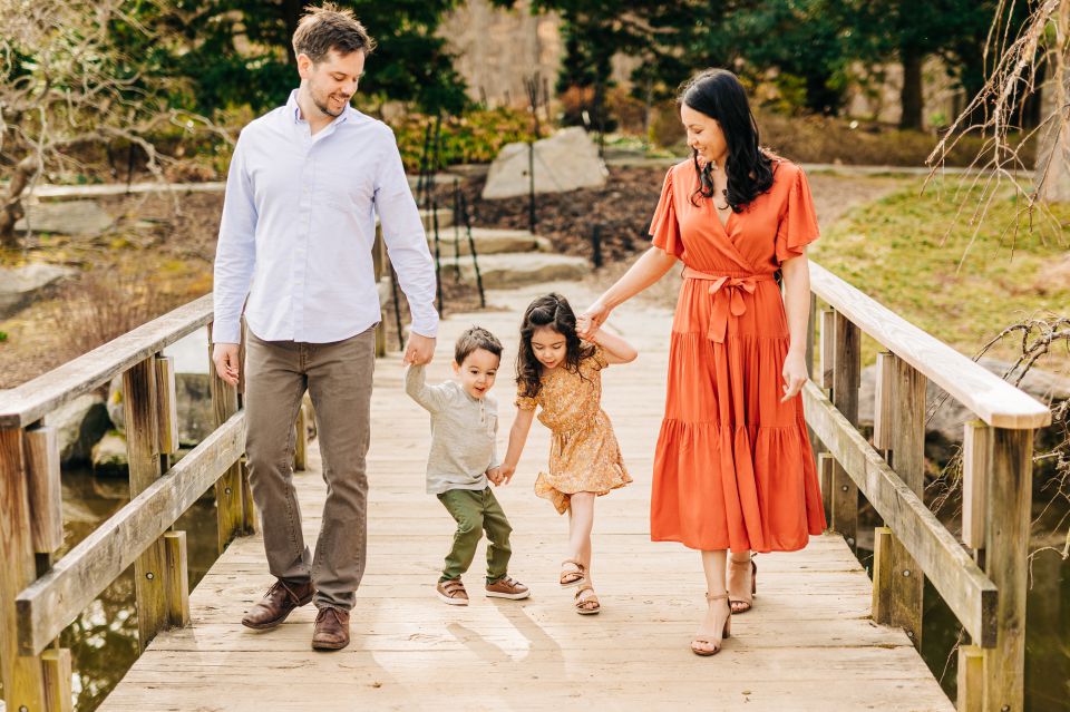 family walks along a bridge at Brookside Gardens in Wheaton, MD