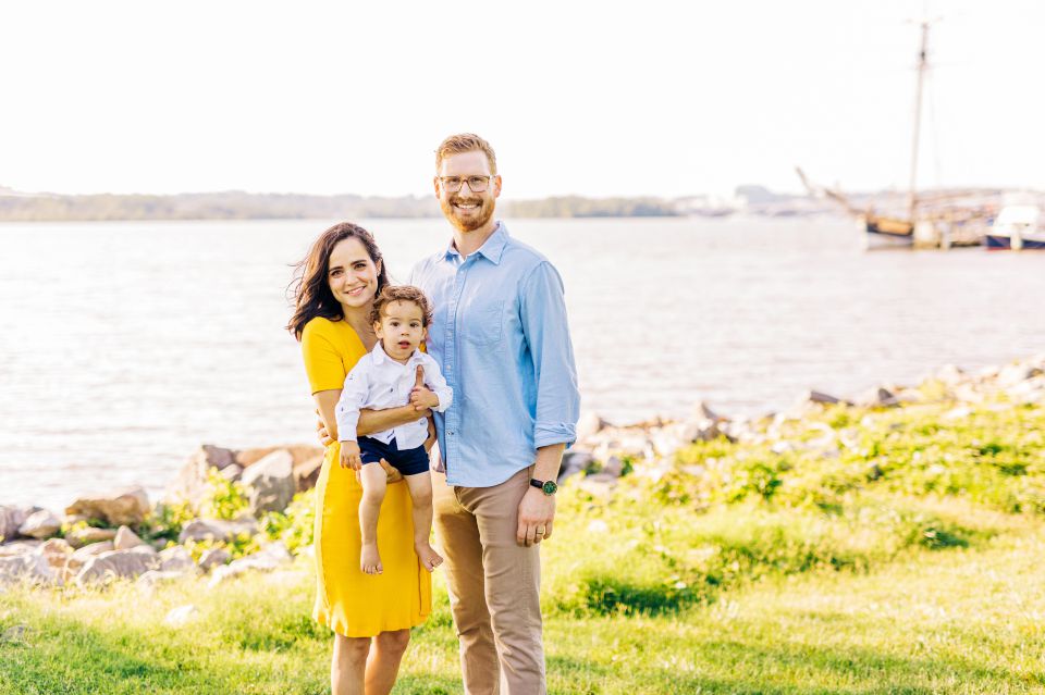Family posing for photos at the Potomac River waterfront in Alexandria, VA