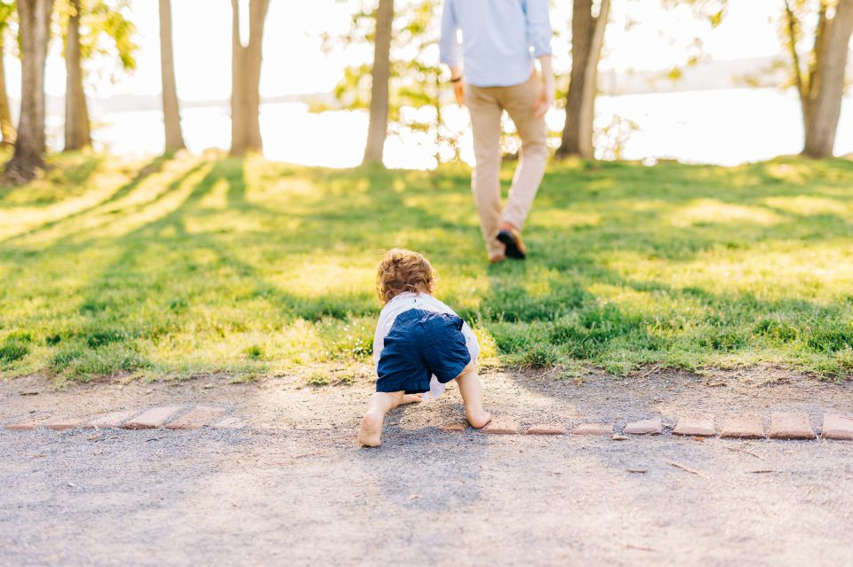 Little boy crawls along dirt path in Founders Park in Alexandria, VA