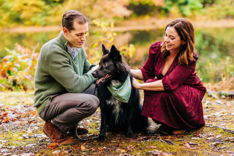 Young couple playing with black sheltie-shepherd mix at Burke Lake in Springfield, VA