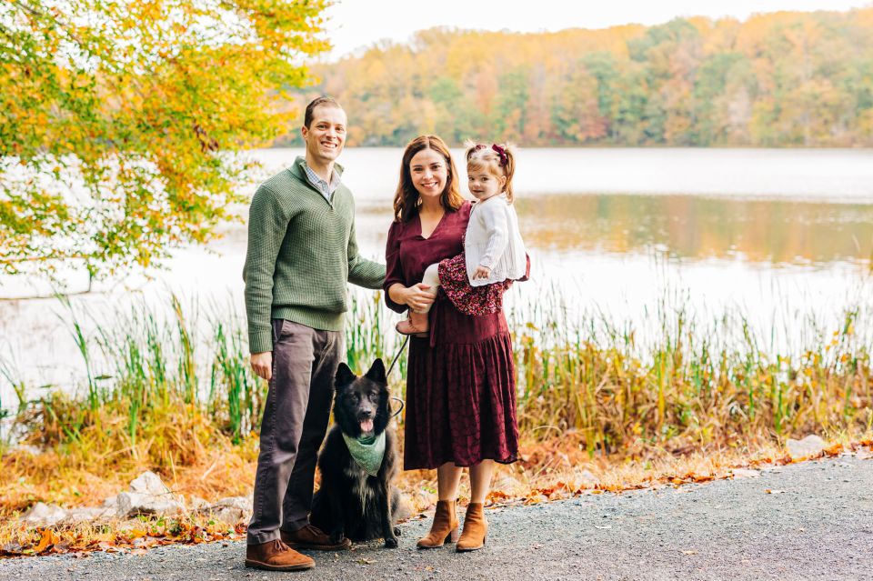Young family and dog posing for photos together at Burke Lake in Springfield, VA