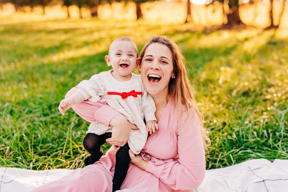 Mother and baby smiling at camera at Manassas Battlefield Park