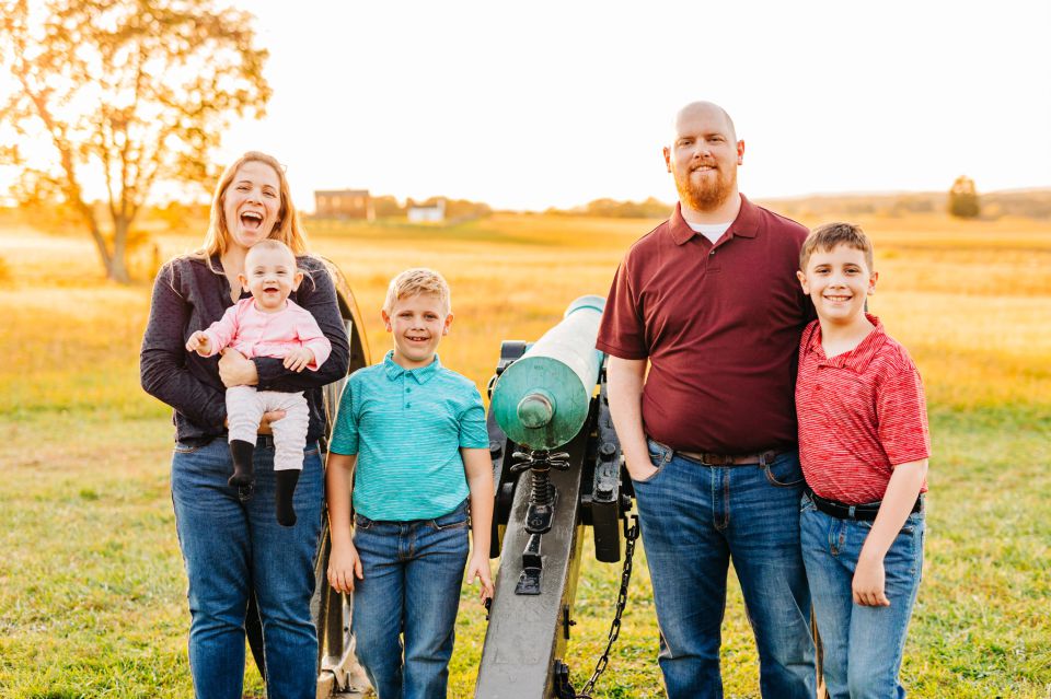 Family posing for photos at Manassas Battlefield Park in Manassas, VA