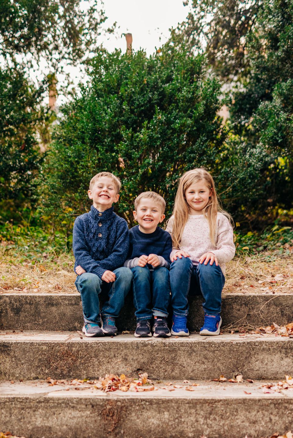 Three kids in sweaters posing for photos in Alexandria, VA