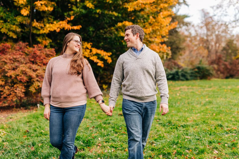 Couple in sweaters and jeans walking through Green Spring Gardens in Northern VA