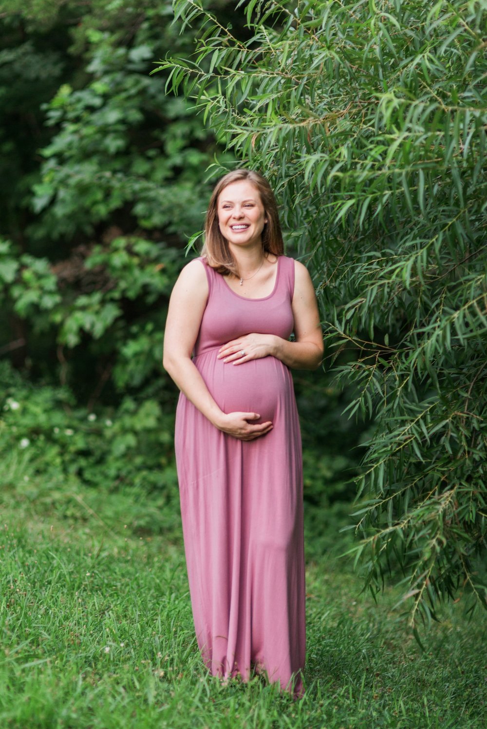 Pregnant woman posing for a maternity session at Lake Mercer in Springfield, VA