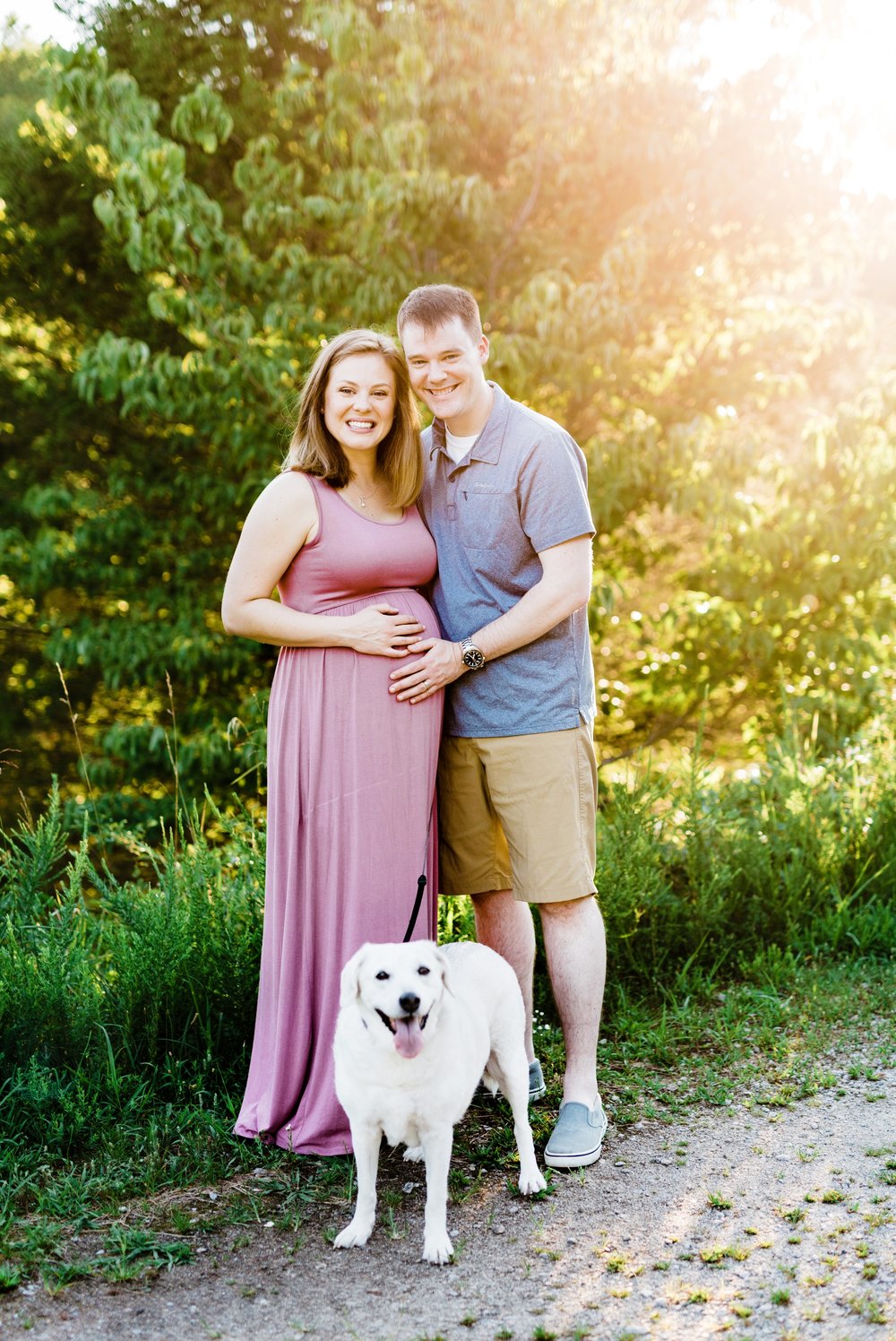 Family and dog posing for a maternity session at Lake Mercer in Springfield, VA